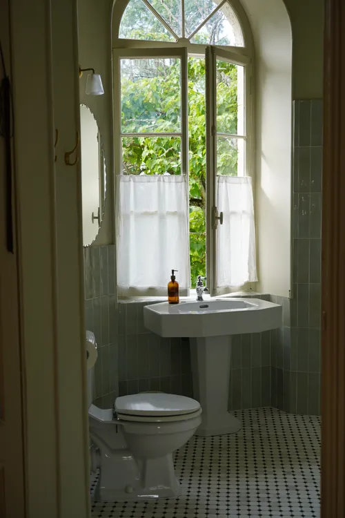 Bathroom with ceramic sink and marble floors
