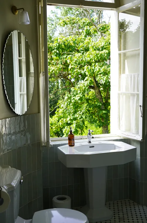 Bathroom with open window and views onto the garden
