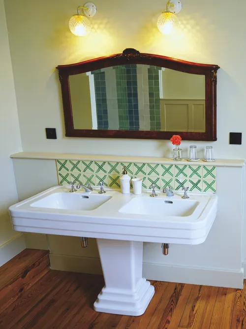 Bathroom sink with handmade tiles and mirror