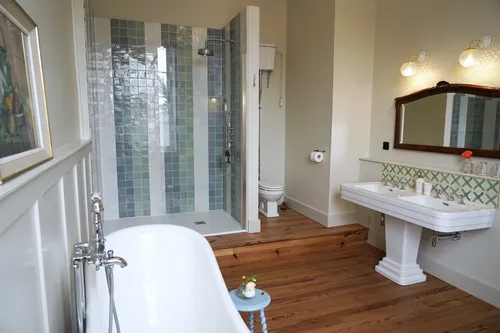 Bathroom with a bathtub, walk in shower and double sink
