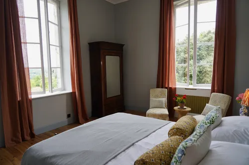 Bedroom with bed and armchairs