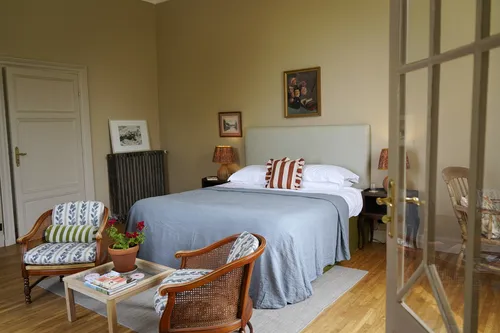 Bedroom with bed and armchairs