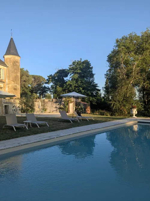 Evening light on the pool and chateau terrace and gardens