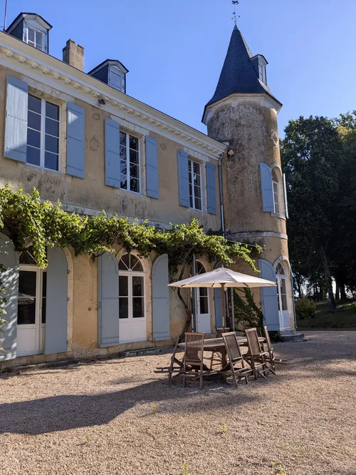 The front terrace and chateau with outside seating and umbrellar