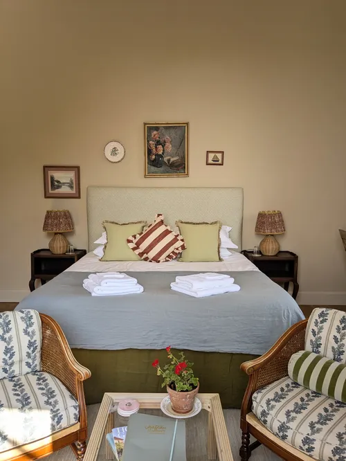 Bed and armchairs with cosy interiors