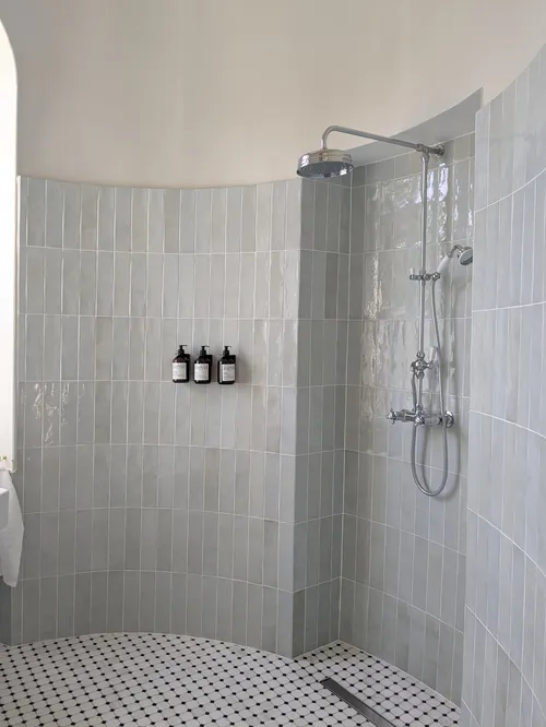 Walking shower and marble floor in a bathroom